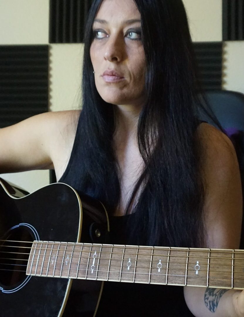 Grable playing her acoustic guitar.